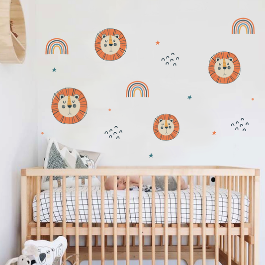 Little Lion and rainbow wall art decals in a nursery setting.