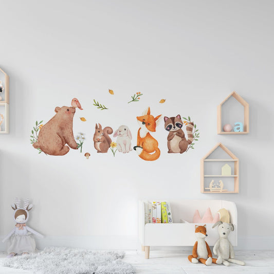 Watercolor wall stickers featuring forest animals including a bear, fox, raccoon, rabbit, and squirrel in a child's room.