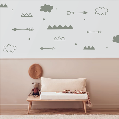 Nature-inspired arrow and cloud wall decals creating a serene atmosphere in a cozy room.